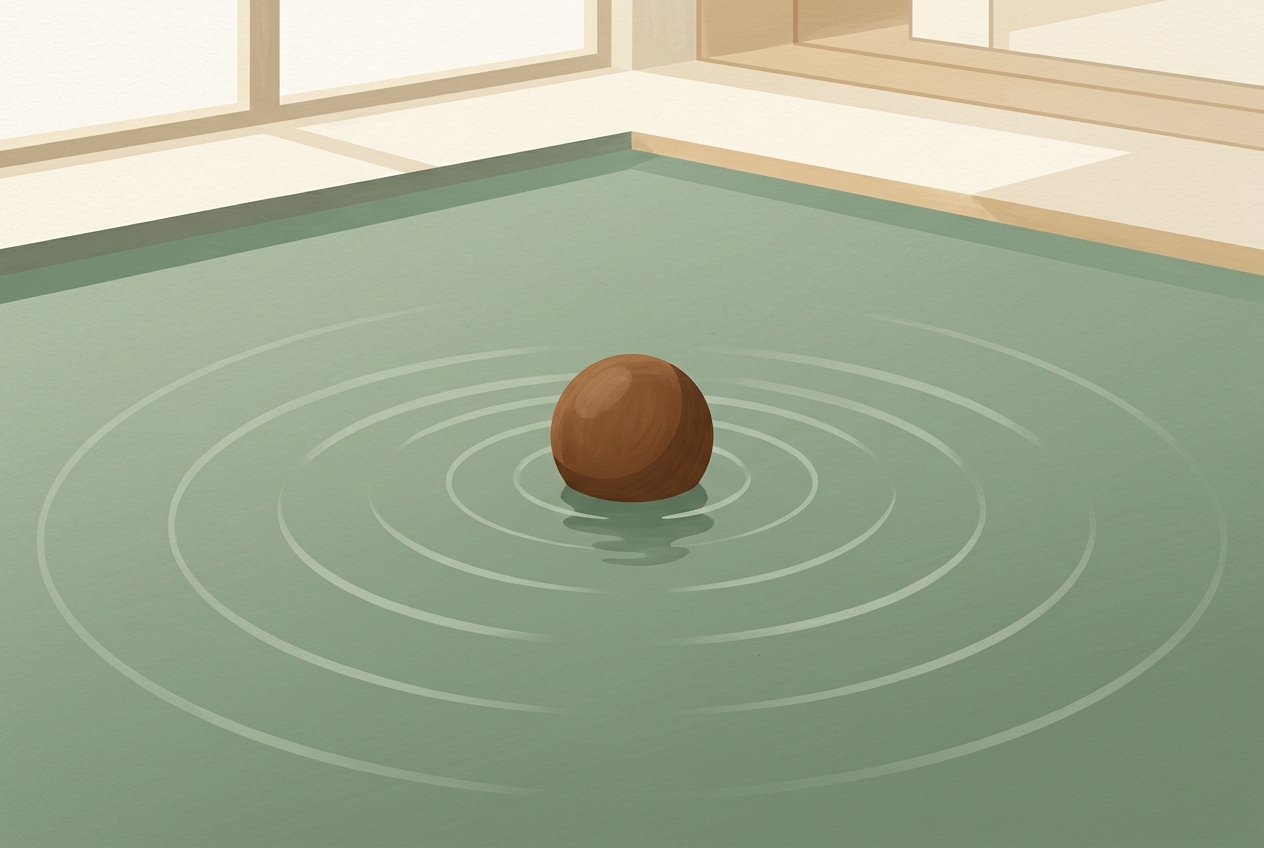 A ball floating on calm water, ripples fading, room visible beyond—the ball stays, undisturbed